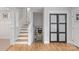 Inviting stairway leading to a cozy living room with a fireplace, complemented by a sliding door at 6609 Pleasant Dr, Charlotte, NC 28211