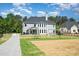 A view of the backyard with a play area including swings, a playground, and a path at 6814 Forney Hill Rd # 2, Denver, NC 28037