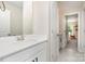 Modern bathroom featuring a white vanity with mirror, tile flooring and door to another room at 6814 Forney Hill Rd # 2, Denver, NC 28037