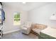 Bright Bedroom featuring a crib, plush chair, window and closet at 6814 Forney Hill Rd # 2, Denver, NC 28037