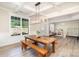 Elegant dining room with a rustic wood table, stylish lighting, and ample space for Gathering gatherings at 6814 Forney Hill Rd # 2, Denver, NC 28037