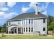 A view of the rear exterior of the home showing a gray exterior, white trim, a patio and a hot tub at 6814 Forney Hill Rd # 2, Denver, NC 28037