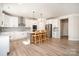 Bright, open kitchen featuring white cabinets, stainless appliances, quartz counters and an island with seating at 6814 Forney Hill Rd # 2, Denver, NC 28037