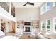 Inviting living room featuring a fireplace, built-in shelves, and large windows offering abundant natural light at 6814 Forney Hill Rd # 2, Denver, NC 28037