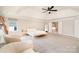 Spacious main bedroom suite featuring tray ceilings, neutral paint, seating, and an ensuite bathroom at 6814 Forney Hill Rd # 2, Denver, NC 28037