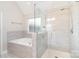 Elegant bathroom with tile surround tub and glass-enclosed shower, offering a spa-like experience at 6814 Forney Hill Rd # 2, Denver, NC 28037