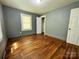 This bedroom features hardwood floors and natural light from the window at 736 7Th Sw Ave, Hickory, NC 28602