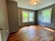 This bedroom features hardwood floors and natural light from the windows at 736 7Th Sw Ave, Hickory, NC 28602