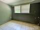 This bedroom features tile floors and natural light from the windows at 736 7Th Sw Ave, Hickory, NC 28602