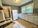 Functional kitchen with essential appliances, tile floors, and ample natural light at 736 7Th Sw Ave, Hickory, NC 28602