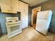 Practical kitchen space featuring standard appliances, tile flooring, and ample cabinet storage at 736 7Th Sw Ave, Hickory, NC 28602