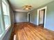 Bright living room features hardwood floors, a classic ceiling fan, and large windows at 736 7Th Sw Ave, Hickory, NC 28602