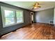 Spacious living room with hardwood floors, ample natural light, and a vintage ceiling fan at 736 7Th Sw Ave, Hickory, NC 28602