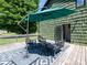 The home has a cozy back deck with an umbrella offering shade and an outdoor dining set at 7728 Babe Stillwell Farm Rd, Huntersville, NC 28078