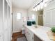 Bathroom with a large vanity, mirror, modern light fixture, tile shower, and hardwood floors at 7728 Babe Stillwell Farm Rd, Huntersville, NC 28078