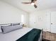 Bright bedroom featuring a ceiling fan, white walls, and a wrought iron bed frame at 7728 Babe Stillwell Farm Rd, Huntersville, NC 28078