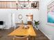 Open concept dining room with wood floors, views of the kitchen and an open second story at 7728 Babe Stillwell Farm Rd, Huntersville, NC 28078