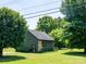 Charming home with green siding, stone accents, and lush landscaping in a peaceful setting at 7728 Babe Stillwell Farm Rd, Huntersville, NC 28078
