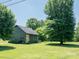 Home with a well-manicured lawn, stone facade, and sunroom, perfect for relaxation and enjoyment at 7728 Babe Stillwell Farm Rd, Huntersville, NC 28078
