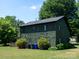 Two-story home with green scalloped siding and manicured landscaping at 7728 Babe Stillwell Farm Rd, Huntersville, NC 28078