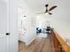 Hallway with a view of the bathroom and the office with a ceiling fan at 7728 Babe Stillwell Farm Rd, Huntersville, NC 28078