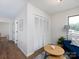 Hallway featuring hardwood floors, closet space, neutral walls, and lots of natural light at 7728 Babe Stillwell Farm Rd, Huntersville, NC 28078