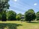 Spacious lot with a well-maintained lawn, mature trees, a storage shed and home at 7728 Babe Stillwell Farm Rd, Huntersville, NC 28078