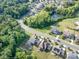 A high angle aerial displays the homes in the neighborhood, amenities, streets, and ponds at 8268 Breton Way, Harrisburg, NC 28075