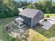 An aerial view displays the rear of the home with a screened porch, backyard, and adjacent three-car garage at 8268 Breton Way, Harrisburg, NC 28075
