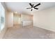 This large bonus room features a ceiling fan and neutral carpet at 8268 Breton Way, Harrisburg, NC 28075
