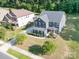 Two-story home with well-manicured lawn, mature landscaping, a basketball hoop, and a paved driveway at 8268 Breton Way, Harrisburg, NC 28075