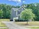 Side view of a two-story home showing the driveway and landscaping at 8268 Breton Way, Harrisburg, NC 28075