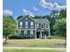 Two-story home featuring a well-manicured lawn and beautiful blue siding at 8268 Breton Way, Harrisburg, NC 28075