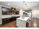 Spacious kitchen featuring a center island, stainless appliances, and dark wood cabinetry at 8268 Breton Way, Harrisburg, NC 28075