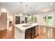 Open kitchen area featuring a center island, stainless steel appliances, and hardwood floors at 8268 Breton Way, Harrisburg, NC 28075