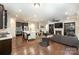 Open-concept living area with a modern kitchen, dining area, and cozy fireplace at 8268 Breton Way, Harrisburg, NC 28075