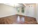 Bright living room featuring hardwood floors, modern lighting, and large windows at 8268 Breton Way, Harrisburg, NC 28075
