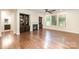 Bright living room featuring a fireplace, built-in bookshelves, and hardwood floors at 8268 Breton Way, Harrisburg, NC 28075