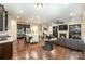 Open-concept living space featuring hardwood floors, recessed lighting, a fireplace, and a kitchen with stainless appliances at 8268 Breton Way, Harrisburg, NC 28075