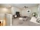 This loft features neutral carpet, a ceiling fan, and modern furniture at 8268 Breton Way, Harrisburg, NC 28075