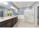 This main bath offers double sinks, a soaking tub, a separate glass enclosed shower, and modern lighting at 8268 Breton Way, Harrisburg, NC 28075