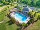Aerial view of community pool and playground with ample seating and a covered pavilion at 8268 Breton Way, Harrisburg, NC 28075