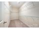 This walk-in closet features carpeted floors, wire shelving, and ample storage space at 8268 Breton Way, Harrisburg, NC 28075