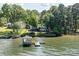 Aerial view of a lakeside home with a dock and gazebo, surrounded by lush greenery and serene waters at 9115 Clement Cir, Terrell, NC 28682