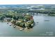 Expansive aerial view of a lakeside home surrounded by lush trees and serene Lake Norman waters at 9115 Clement Cir, Terrell, NC 28682