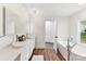Bright bathroom featuring dual sinks, modern fixtures, and a freestanding soaking tub at 9115 Clement Cir, Terrell, NC 28682