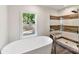 Bright bathroom features a soaking tub, separate shower with stylish tile, and a large window at 9115 Clement Cir, Terrell, NC 28682