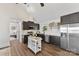 Bright kitchen with stainless steel appliances, a kitchen island, and dark cabinets at 9115 Clement Cir, Terrell, NC 28682