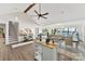 Living area with vaulted ceiling that opens to the kitchen, showcasing hardwood floors and light-filled spaces at 9115 Clement Cir, Terrell, NC 28682