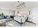 Spacious main bedroom with a modern light fixture, sitting area, and neutral decor at 9115 Clement Cir, Terrell, NC 28682